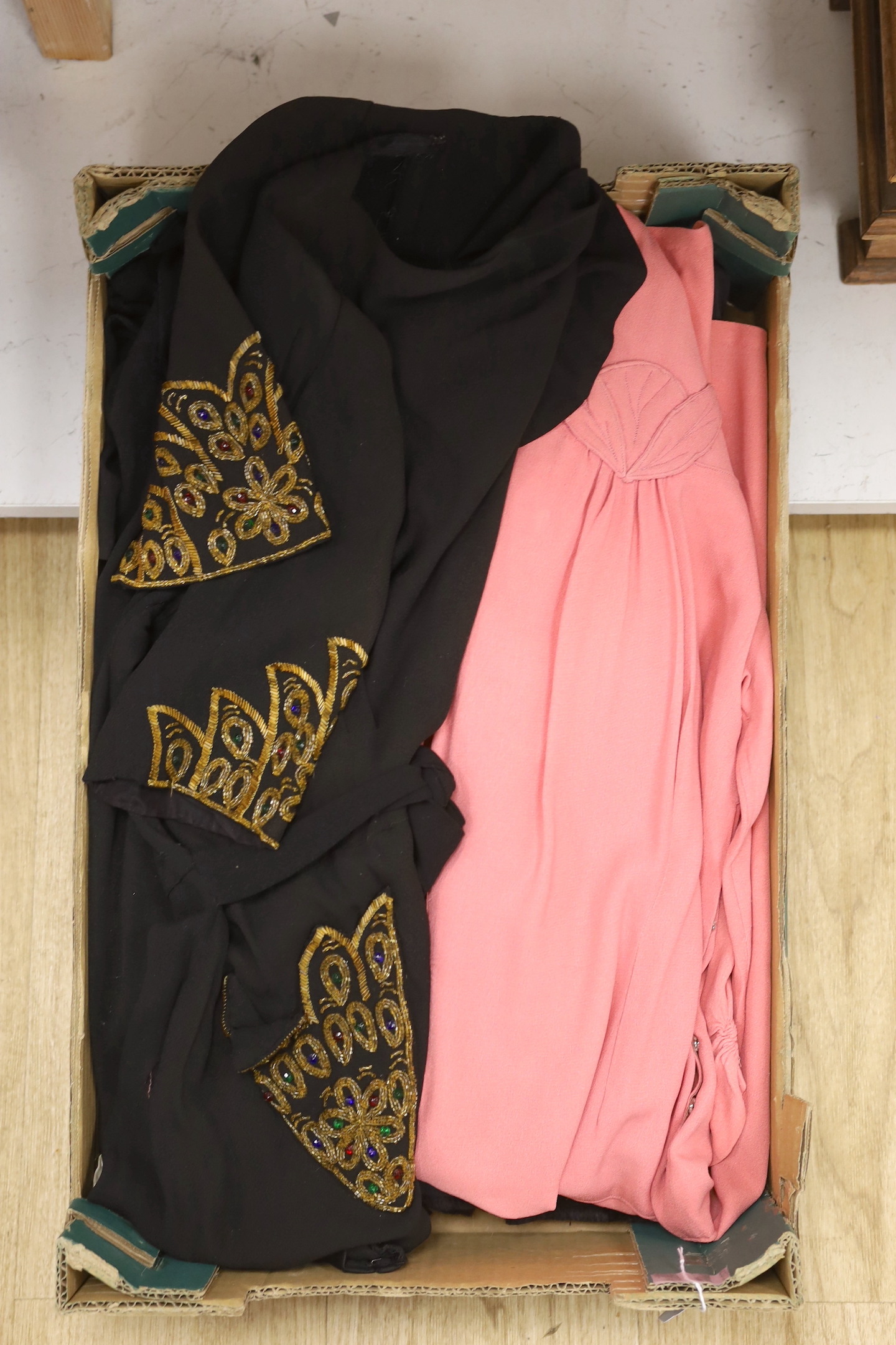 A 1940's ladies beaded and embroidered black crepe evening dress and a pink crepe day dress and a 19th century black skirt and jacket